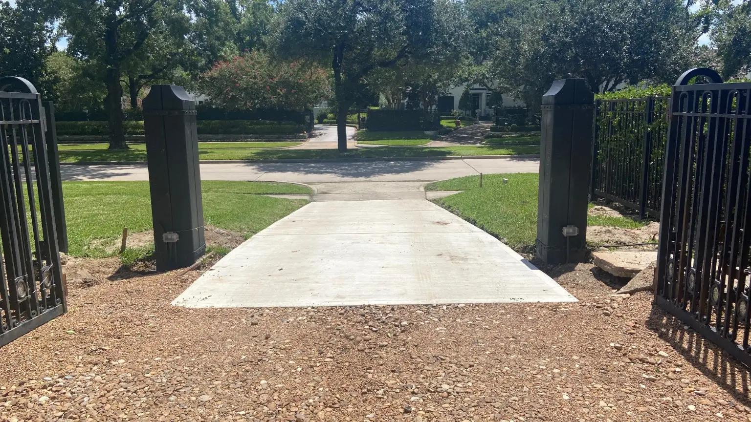 Wide view of the completed driveway entrance looking toward the street