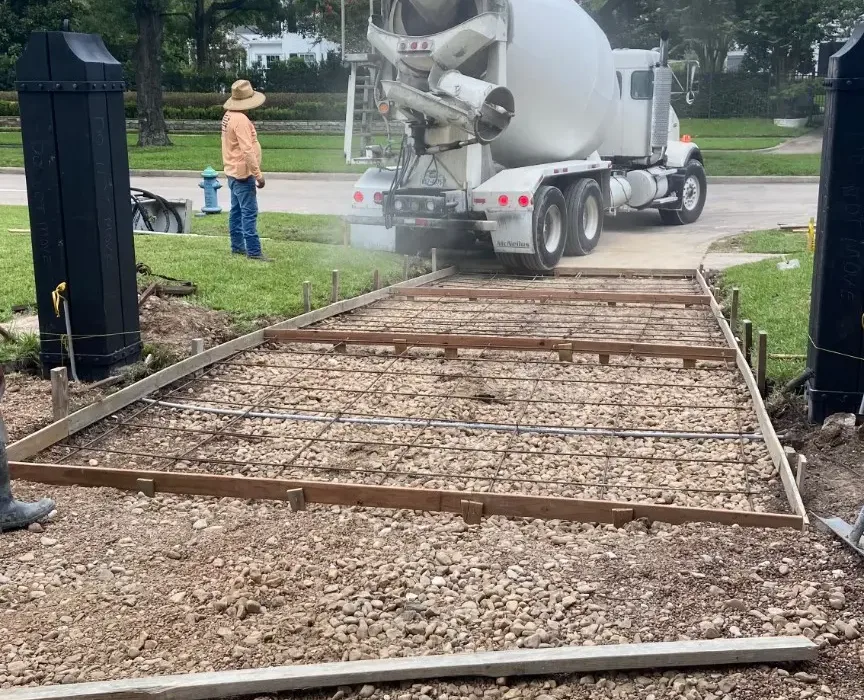 Concrete truck positioned beside the prepared residential driveway