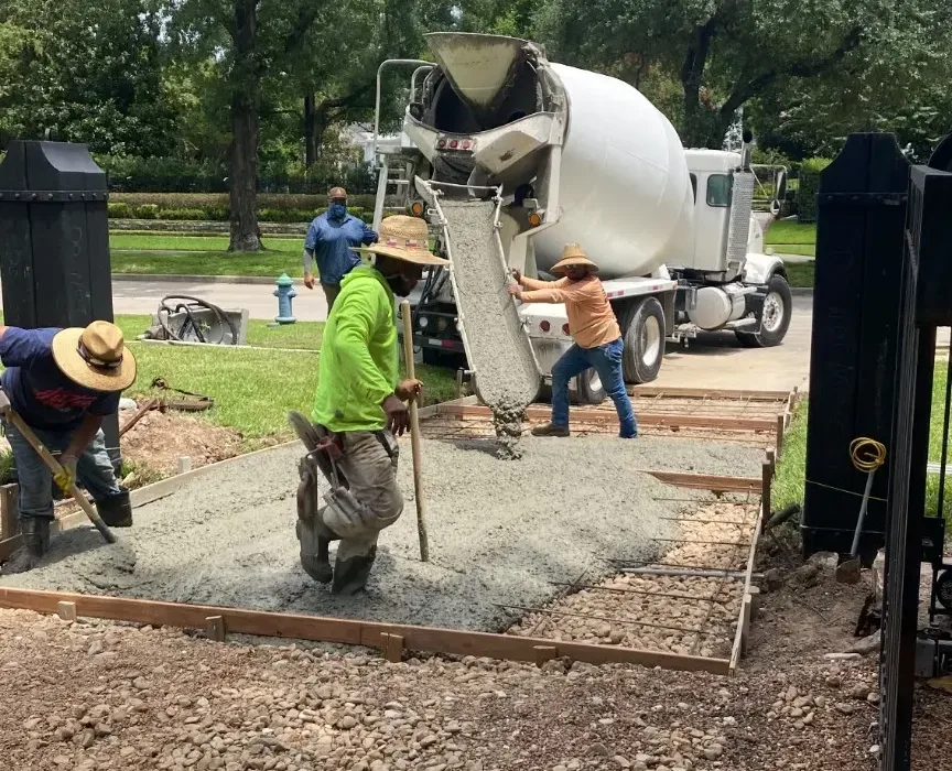 Fresh concrete being placed into the reinforced driveway formwork